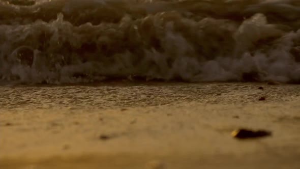 Middle to high waves at the beach and the light of sunrise in the morning.