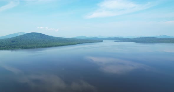 Flying Over a Mountain Lake in the Morning