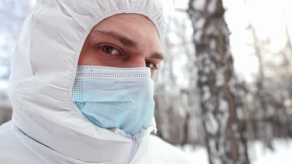 Closeup of a Masked Doctor Against the Backdrop of a Winter Forest