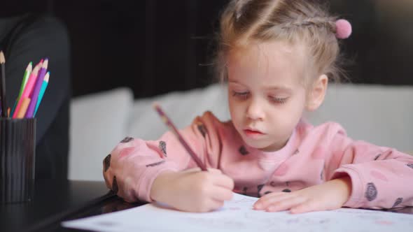 Child Drawing Sitting on Table Middle Shoot