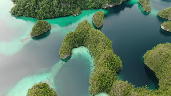 Aerial View Of Triton Bay With Turquoise Sea And Green Tropical Trees In Kaimana Islands