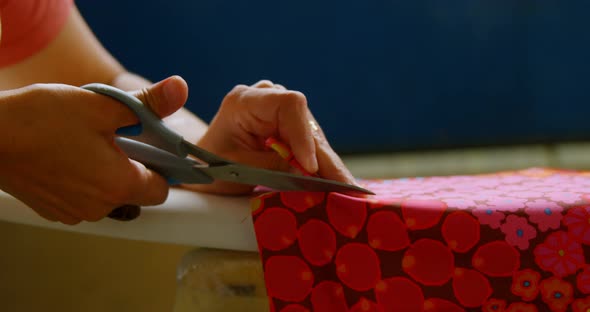 Woman cutting fabric for surfboard 4k