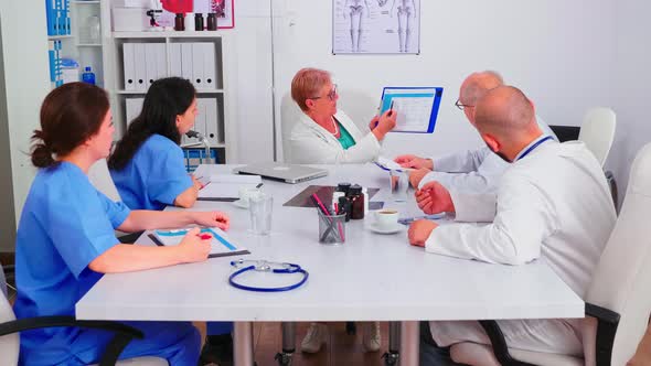 Experienced Doctors in Hospital Meeting Room Working Together