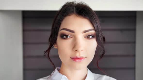 Closeup Face of Confident Caucasian Stylish Woman with Perfect Makeup Looking at Camera