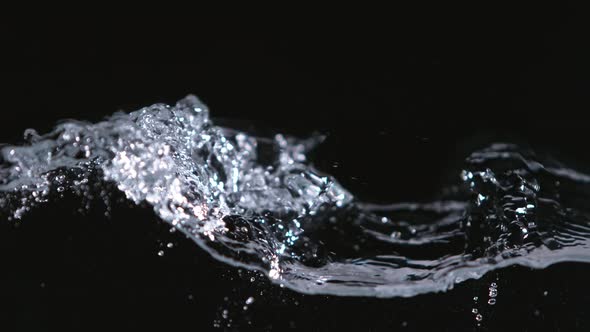 Super Slowmotion Shot of Water Wave Against Black