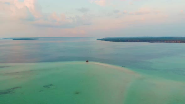 Aerial: uncontaminated coastline beach sunset at Kei Islands Indonesia