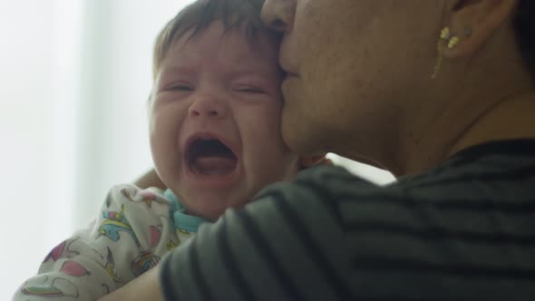 Slow Motion of Grandmother Trying to Console Crying Baby