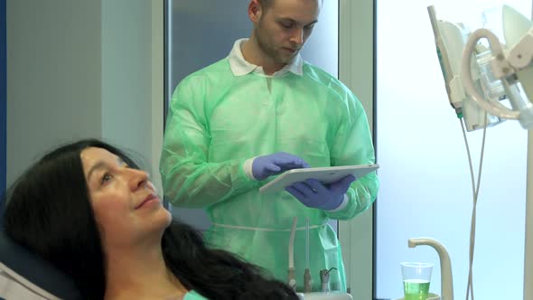 Woman Demonstrates Her Teeth at the Dentist