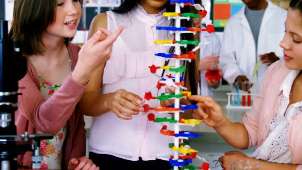 School students experimenting molecule model in laboratory