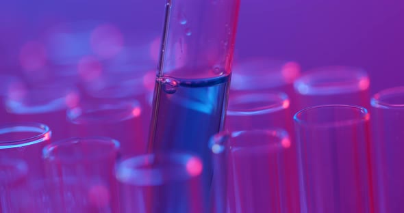 Pipette drips  chemicals into a test tube