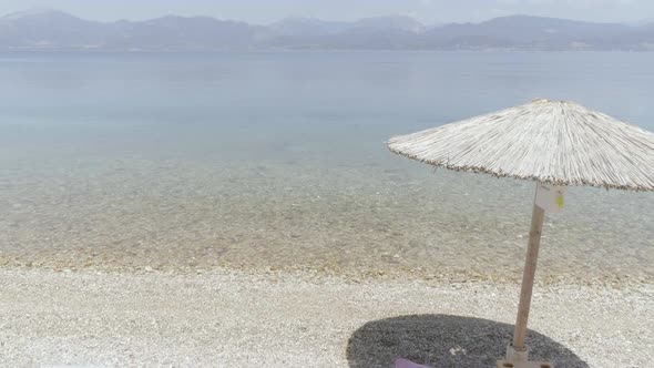 Aerial view of two women sits on the beach in Panagopoula, Greece.