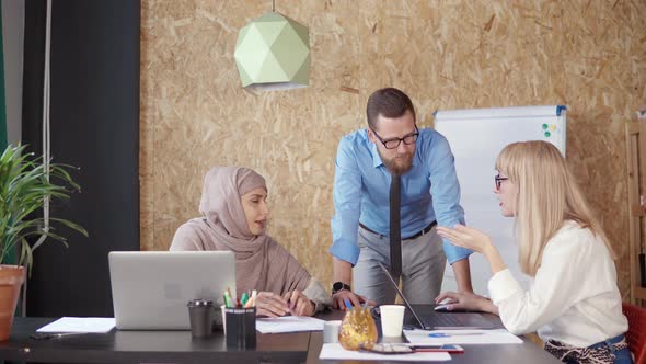 Man and Two Women in Modern Office.