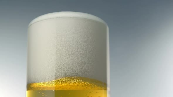 Beer foam sits at top of glass, Slow Motion