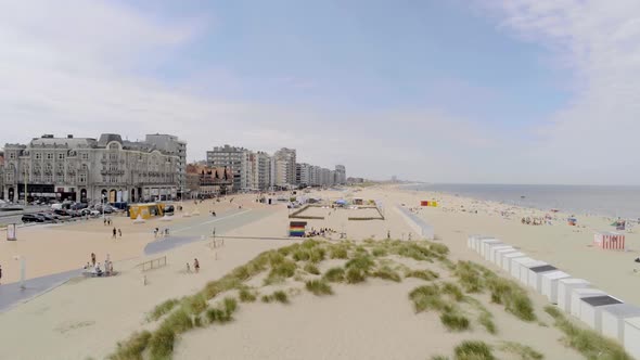 Beautiful panoramic beach of Nieuwpoort with sand dunes and buildings on a sunny day with blue sky,