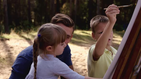 Happy Family Young Father Drawing Coloring Picture with Brush Helping Cute Child Daughter Enjoying