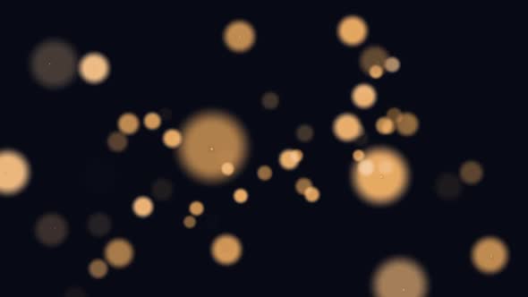 Animation of glowing orange spots of light moving in hypnotic motion on black background alt