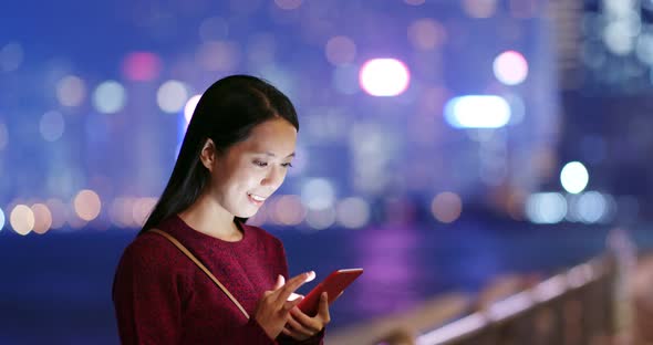 Woman use smart phone online at night