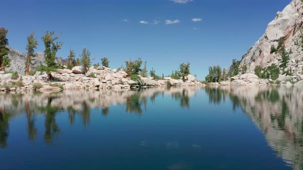 Cinematic Aerial of Blue Glacier Lake with Smooth Surface with Vivid Sky  USA