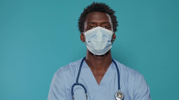 Close Up of Medical Assistant with Face Mask Looking at Camera