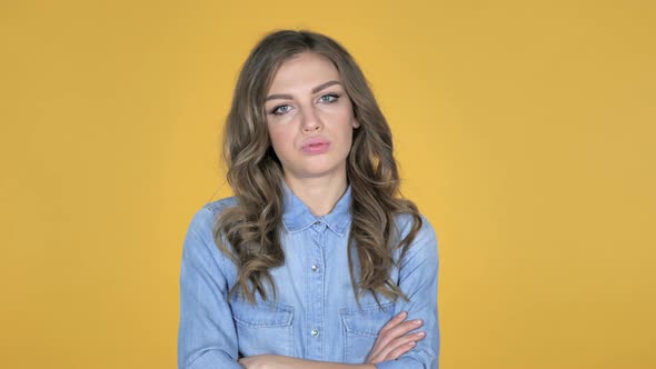 Sad Upset Young Girl Isolated on Yellow Background