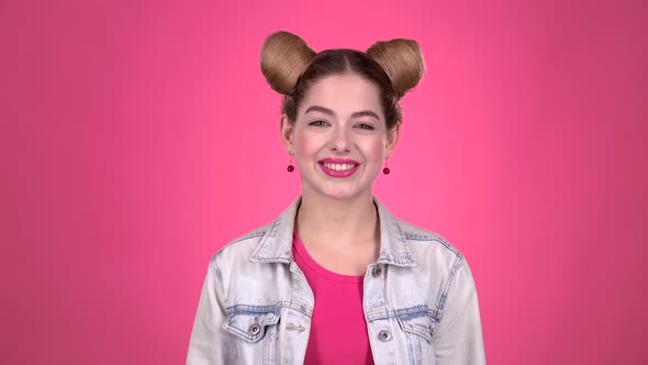 Girl Teenager Shows Thumbs Up. Pink Background