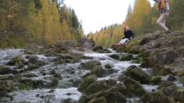 Little Cute Girl Playing on the Shore of the Forest Stream