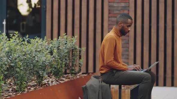 Time Lapse of African American Businessman Working on Street Bench