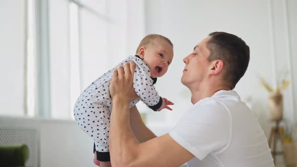 Funny Game and Laugh of Caucasian Man and Baby Boy in Domestic Comfort