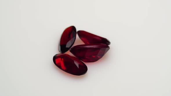 Natural Red Garnet Gemstone on the White Background on the Turning Table