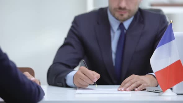 French Official Signing Docs About State Business Support, Shaking Partner Hand