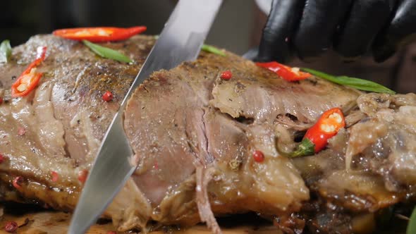 Chef Slicing Delicious CrispySkinned Roast Young Goose with Sharp Knife