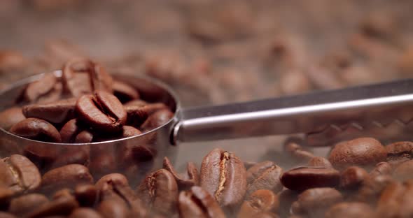 Close Up of Seeds of Coffee. Fragrant Coffee Beans Are Roasted Smoke Comes From Coffee Beans.