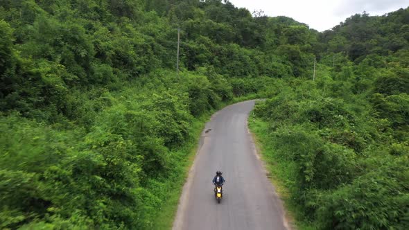 Woman Riding Motorbike On The Road