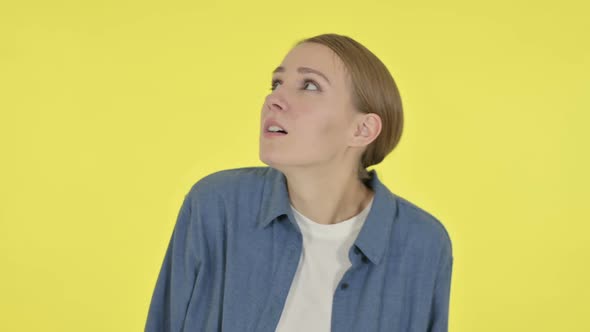 Young Woman Feeling Scared Frightened on Yellow Background