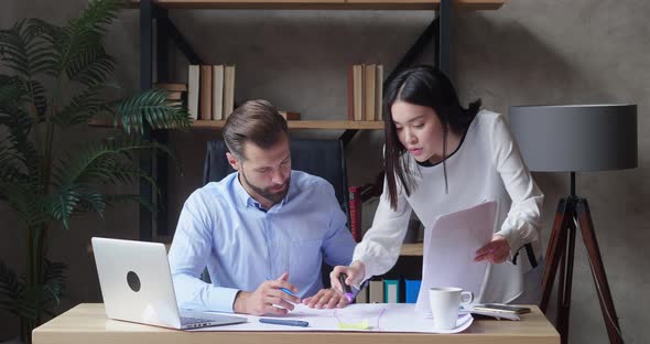 Businessmen and Asian Woman Working on Financial Statistics Analyzing Charts Project Data in Report