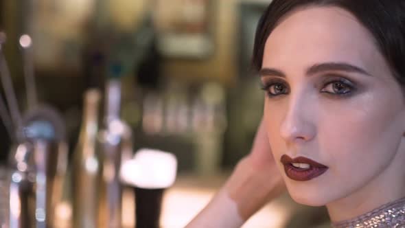 Closeup Portrait of a Young Attractive Woman in a 1920s Style at the Bar