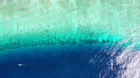 Tropical fly over clean view of a white sand paradise beach and blue water background in colorful 4K