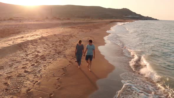 Young Couple Walking on Beach