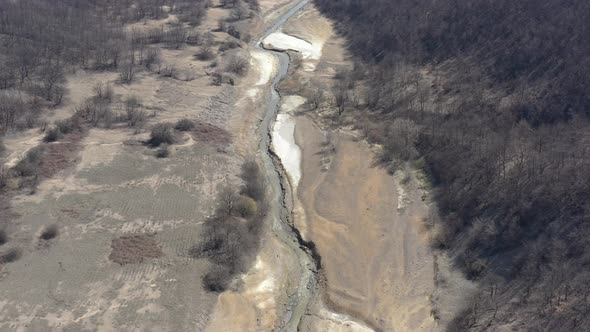 Mining drainage waste on river coast 4K drone video