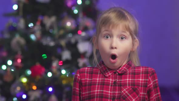 Surprised Child Against the Background of Blurry Lights