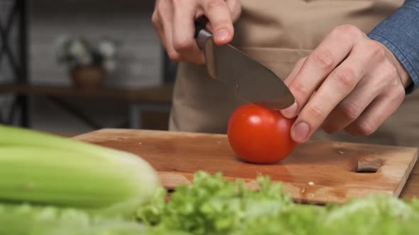 Cooking Salad at Home Man Hands Slicing a Tomato for a Salad