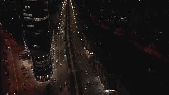 Aerial View From Drone on Glass Facade of Modern Skyscraper with Offices at Night