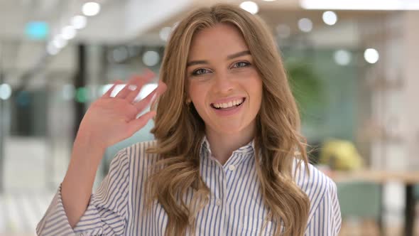 Portrait of Cheerful Businesswoman Waving at the Camera