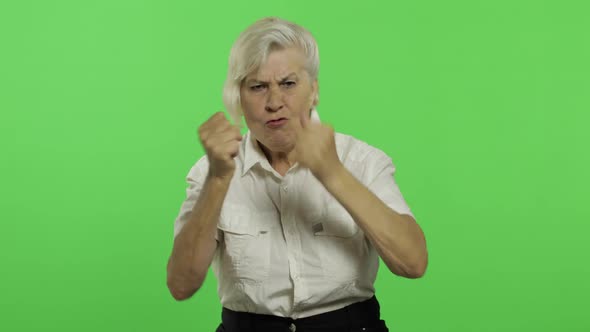 An Elderly Woman Quarrels at Someone. Old Grandmother. Chroma Key