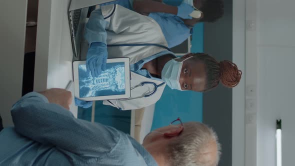 Vertical Video Young Doctor Analyzing x Ray on Digital Tablet