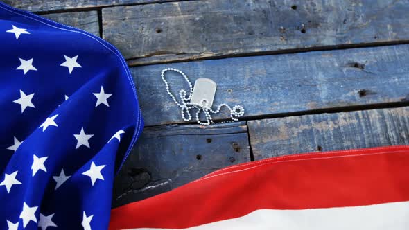 American flag and dog tag on a wooden table