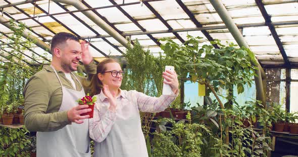 A Young Couple is Telling Their Friends About Their Greenhouse During an Online Video Call