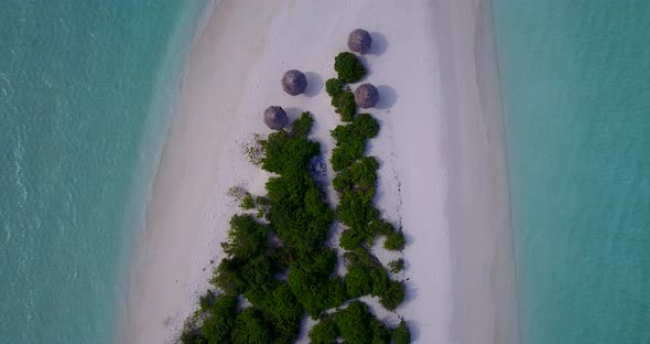 Beautiful flying abstract view of a sandy white paradise beach and aqua turquoise water background