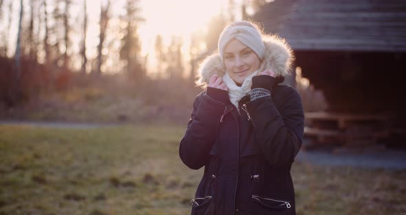 Smiling Woman with White Scarf Looking Into Camera