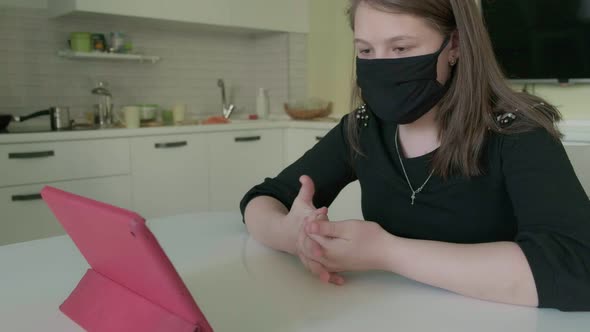 Two Young Women Are Talking Via Video Link in Medical Masks